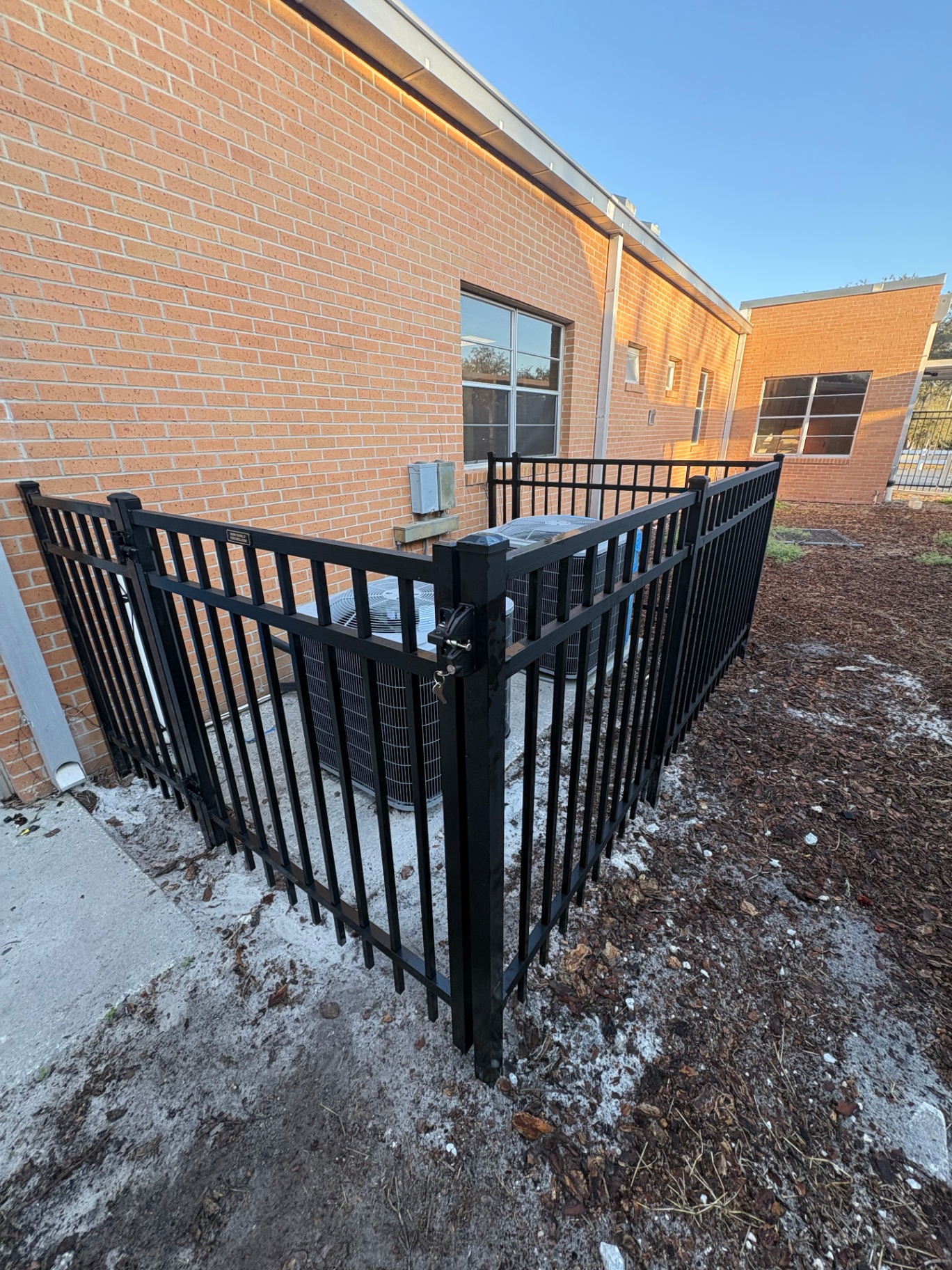 Black aluminum equipment enclosure with locking gate