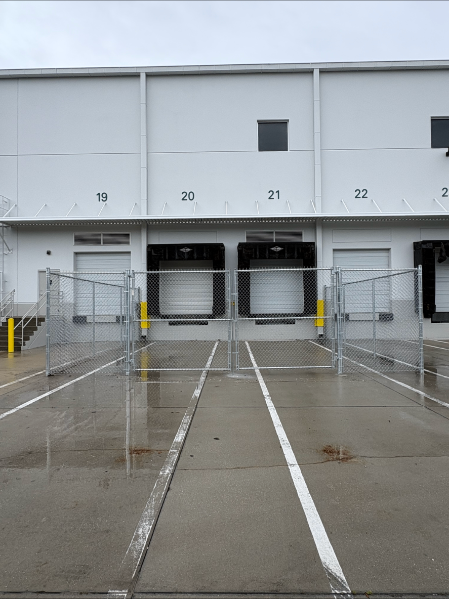Commercial chain link gate installation at loading dock